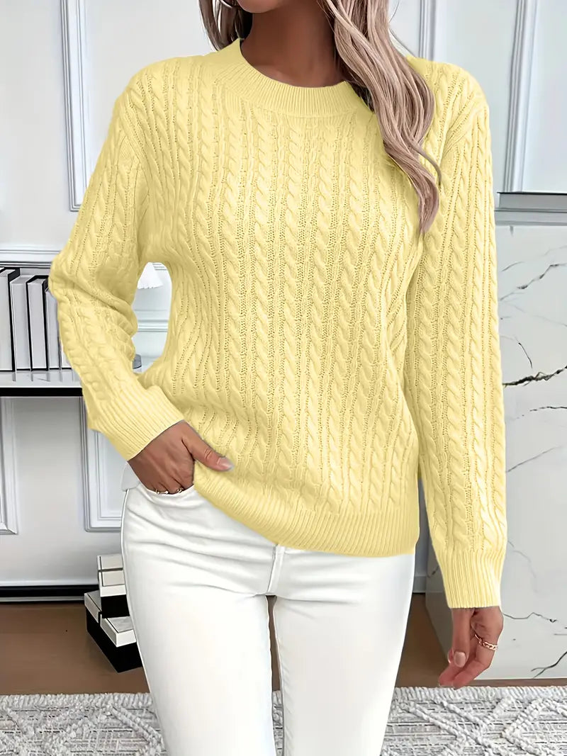 Yellow - Women's light pink cable knit sweater with long sleeves and a crew neckline, worn with white pants.