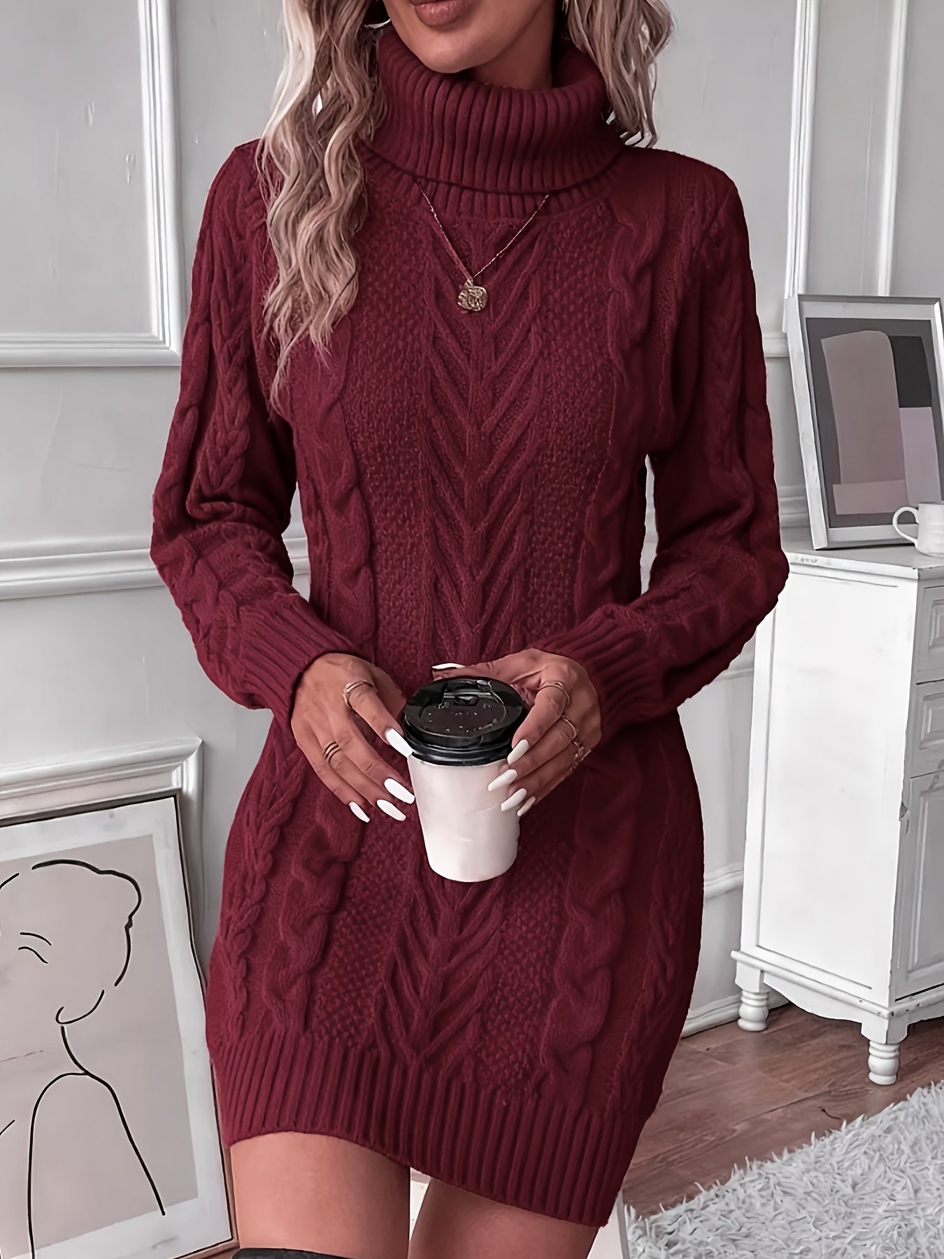 Crimson - Woman wearing a heavyweight cable knit long sleeve mini dress with a high roll neck and ribbed hem.