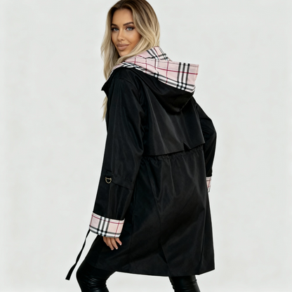 Beige - A woman wearing a taupe mid-length hooded jacket with a black zip front, featuring a distinctive black, white, and red check lining visible in the hood and rolled cuffs.