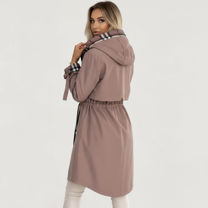 Black - A woman wearing a taupe mid-length hooded jacket with a black zip front, featuring a distinctive black, white, and red check lining visible in the hood and rolled cuffs.