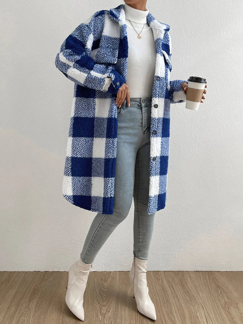 Blue - Women's longline teddy coat featuring a large pink and white check pattern, collared neckline, and button-front closure, styled over a ribbed knit top and white denim.