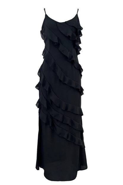 Black - A woman wearing a vibrant red chiffon maxi dress with cascading diagonal ruffles, a V-neckline, and thin spaghetti straps, posing against a rustic dark wooden door.