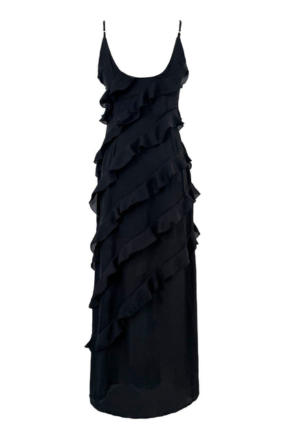 Black - A woman wearing a vibrant red chiffon maxi dress with cascading diagonal ruffles, a V-neckline, and thin spaghetti straps, posing against a rustic dark wooden door.