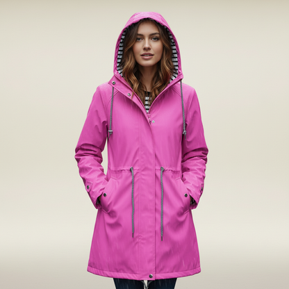 Pink - A woman wearing a vibrant red mid-length raincoat with a striped hood lining, featuring a drawstring waist and snap-button details, set against a neutral background.