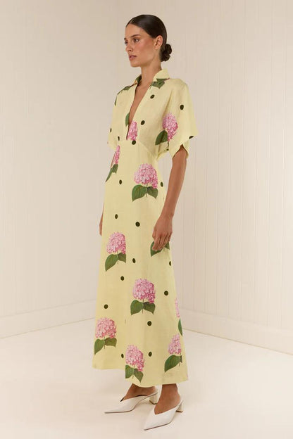 Yellow - Women's pale yellow maxi dress featuring a deep V-neck collar, short sleeves, and a vibrant pink floral and dark polka dot print.