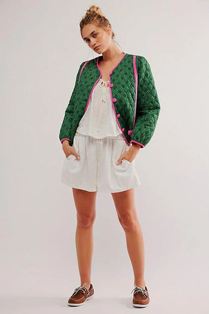 Green - Women's green diamond-quilted cropped jacket featuring a tiny floral print, bright pink contrast trim, and fabric-covered button closures, styled open over a white top.