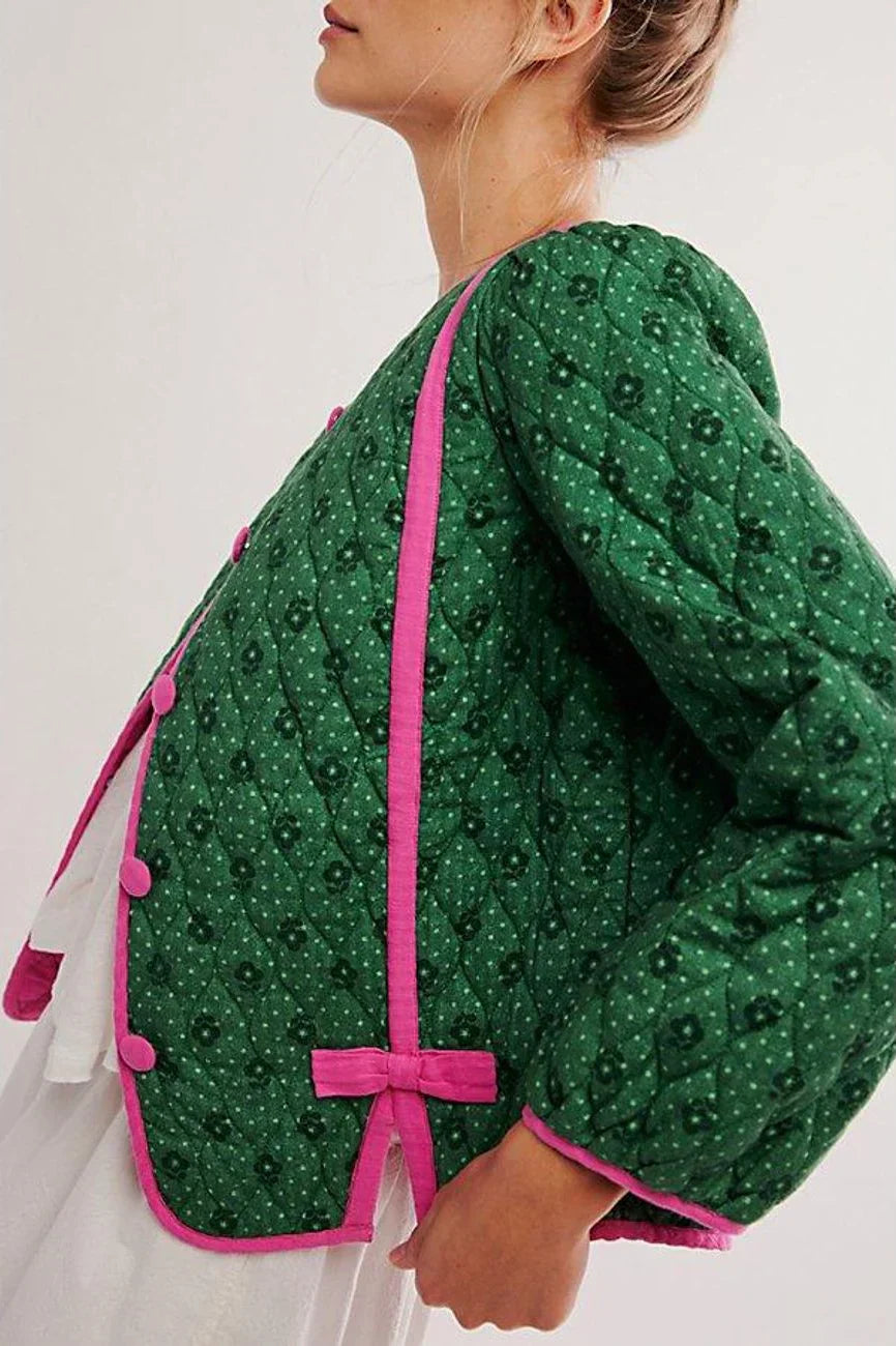 Green - Women's green diamond-quilted cropped jacket featuring a tiny floral print, bright pink contrast trim, and fabric-covered button closures, styled open over a white top.