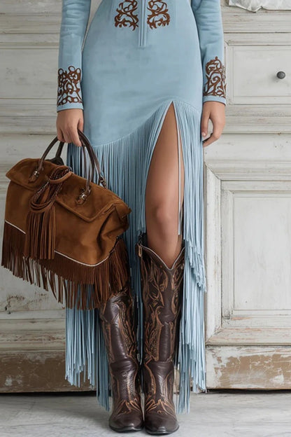 Blue - Woman wearing a long-sleeve maxi dress with intricate chest embroidery, an adjustable zip-front neckline, and a dramatic floor-length fringed skirt with a high leg slit, styled with western boots.