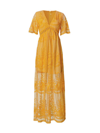Women's resort maxi dress featuring a deep V-neckline, short flutter sleeves, and intricate floral lace embroidery on a sheer overlay with a partial lining.