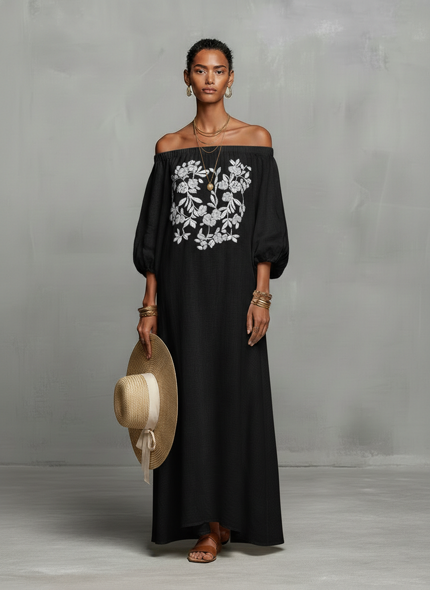 Black - A woman wearing an off-the-shoulder cream linen maxi dress with tonal chest embroidery and puff sleeves, holding a wide-brim straw hat.