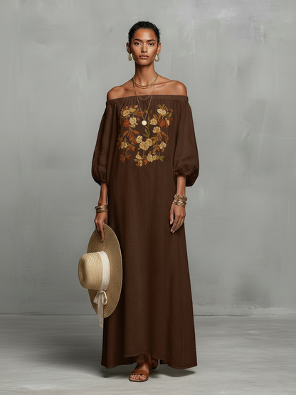 Brown - A woman wearing an off-the-shoulder cream linen maxi dress with tonal chest embroidery and puff sleeves, holding a wide-brim straw hat.