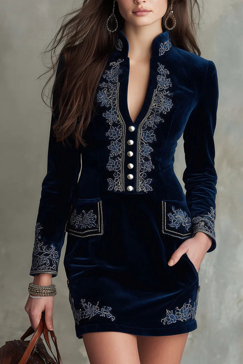 Blue - Woman wearing a velvet long-sleeve mini dress with floral embroidery, deep V-neckline, front buttons, and patch pockets