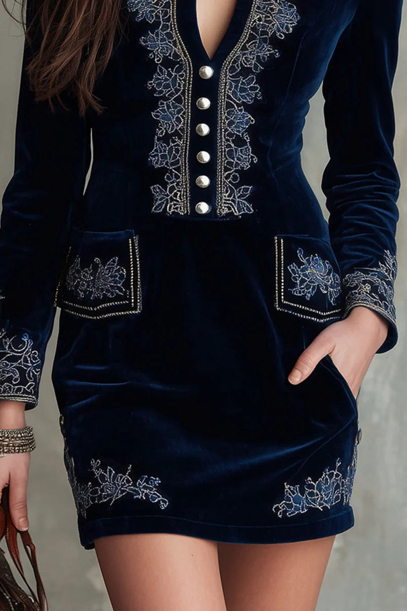 Blue - Woman wearing a velvet long-sleeve mini dress with floral embroidery, deep V-neckline, front buttons, and patch pockets