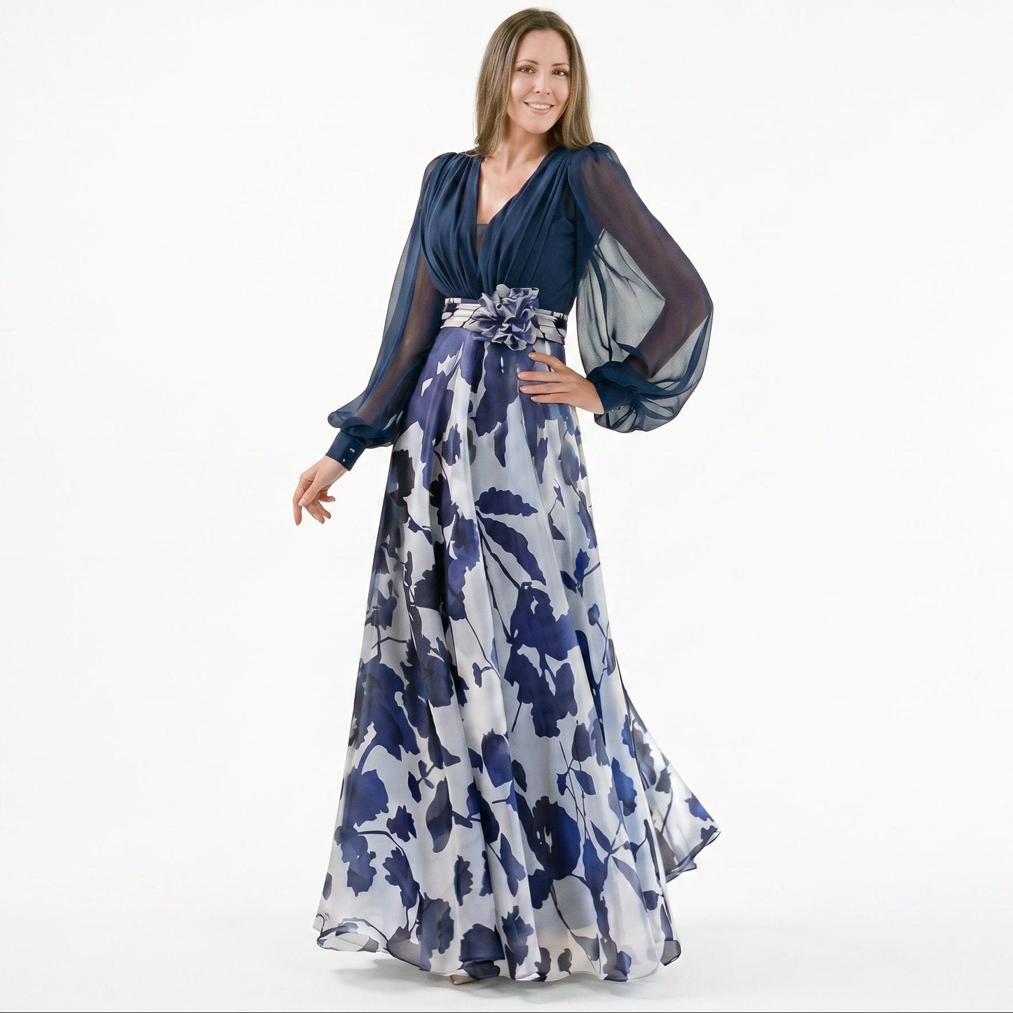 Navy Blue - A woman posing in a floor-length navy and white floral chiffon maxi dress featuring a deep V-neckline, sheer balloon sleeves, and a 3D floral applique at the waist.