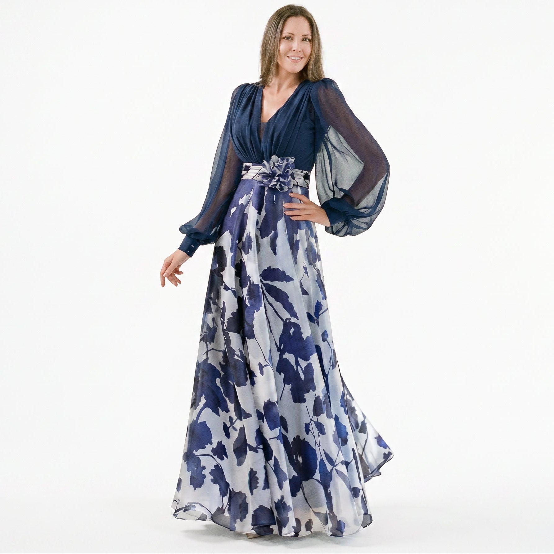 Navy Blue - A woman posing in a floor-length navy and white floral chiffon maxi dress featuring a deep V-neckline, sheer balloon sleeves, and a 3D floral applique at the waist.
