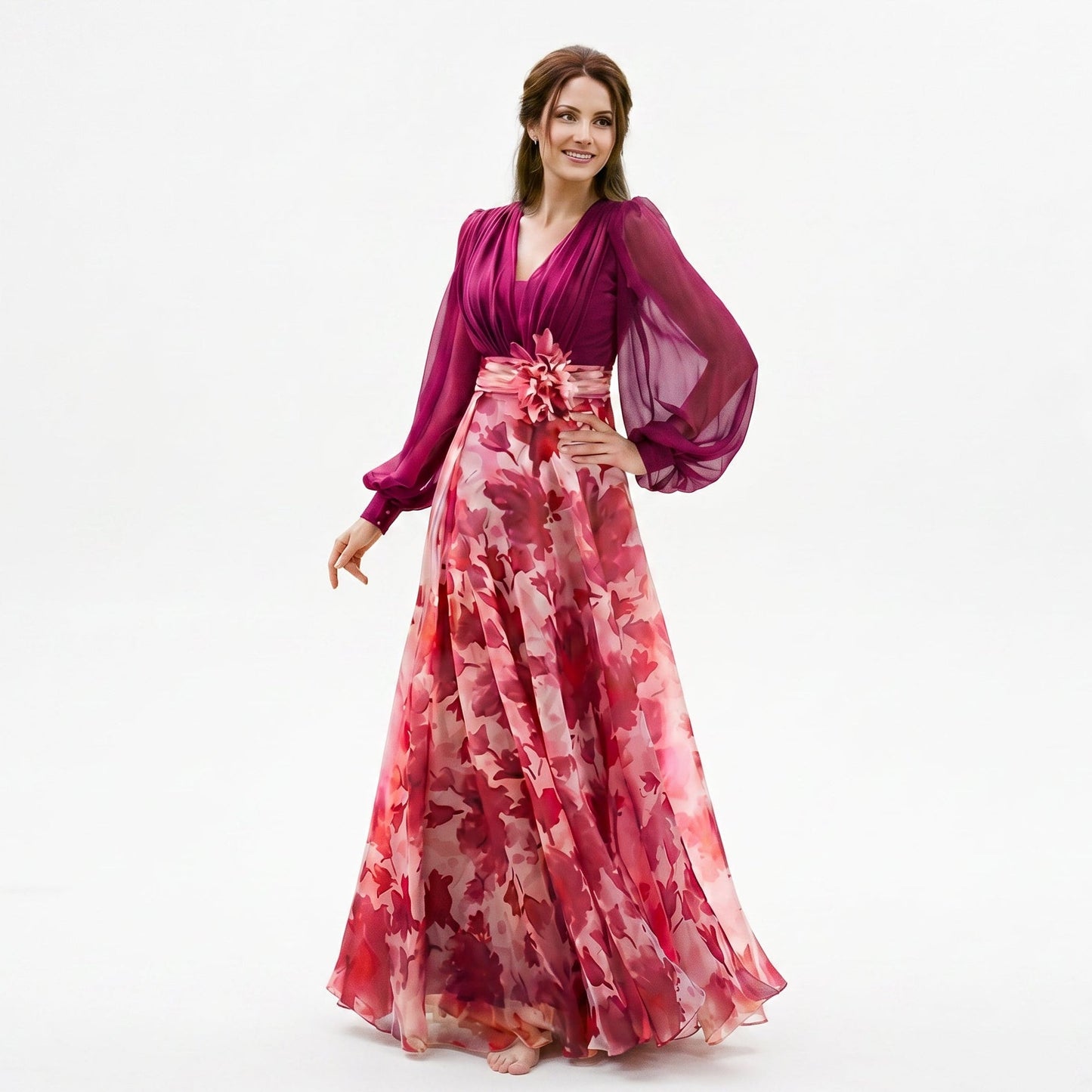 Bubblegum Pink - A woman posing in a floor-length navy and white floral chiffon maxi dress featuring a deep V-neckline, sheer balloon sleeves, and a 3D floral applique at the waist.