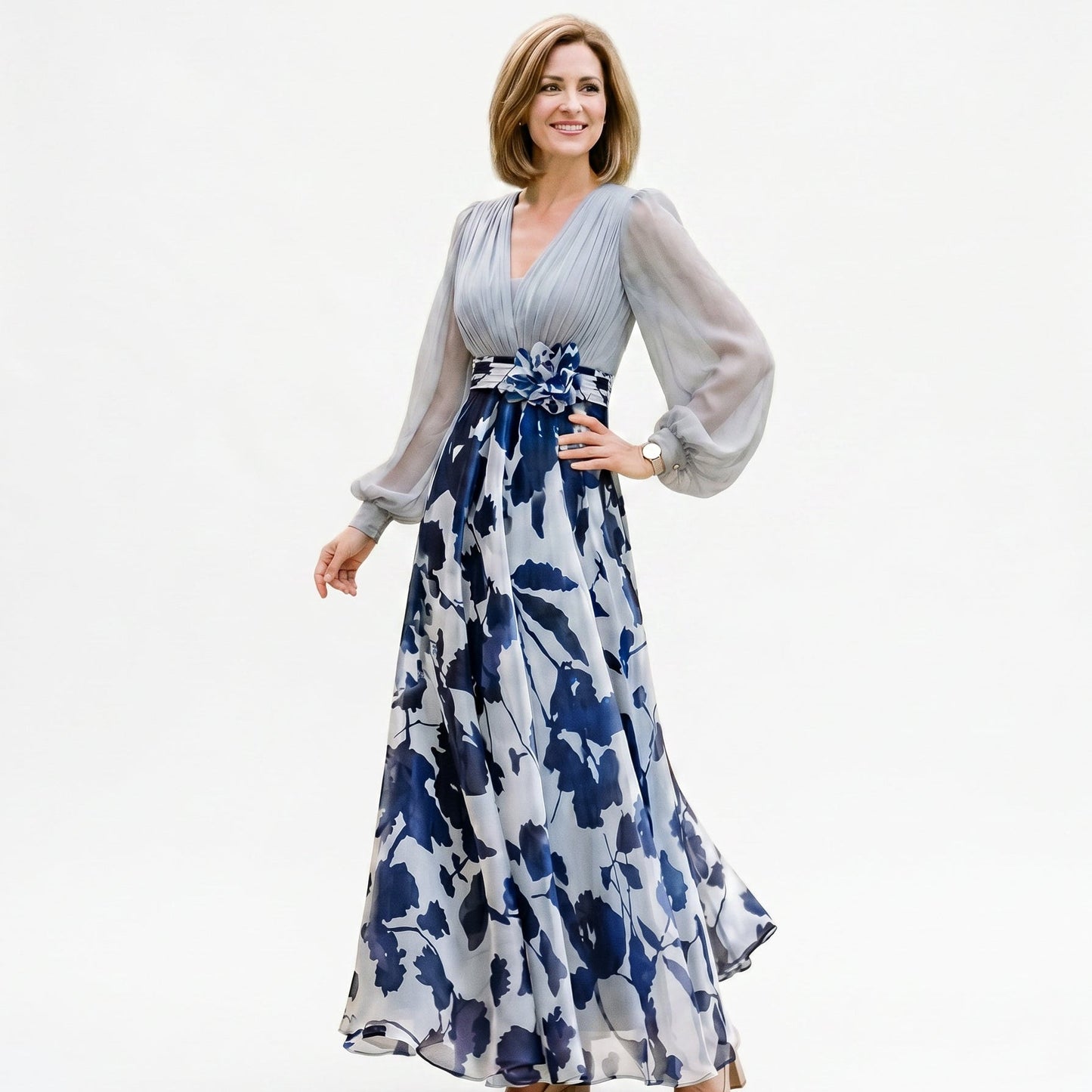 Pale Blue - A woman posing in a floor-length navy and white floral chiffon maxi dress featuring a deep V-neckline, sheer balloon sleeves, and a 3D floral applique at the waist.