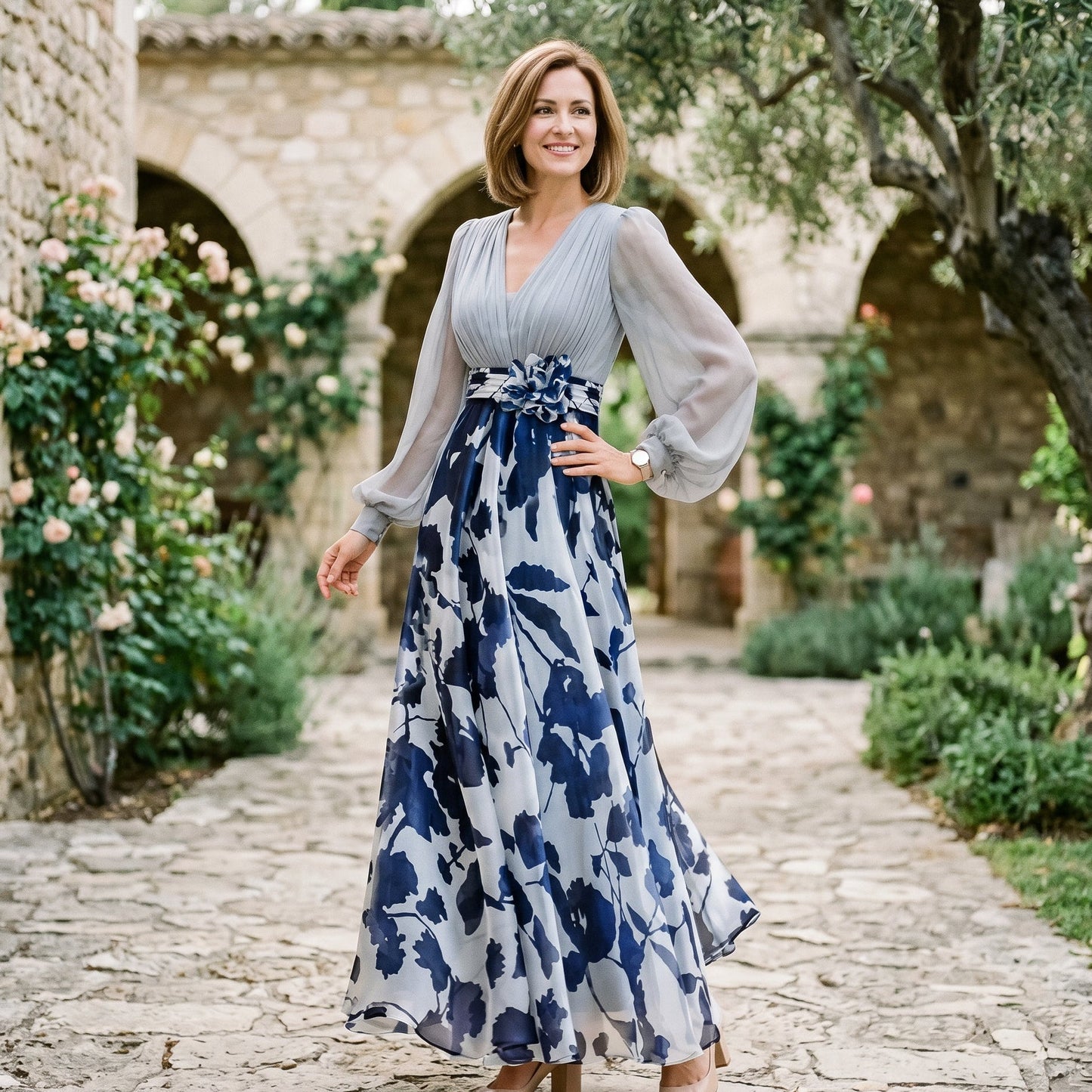White&Wine Red - A woman posing in a floor-length navy and white floral chiffon maxi dress featuring a deep V-neckline, sheer balloon sleeves, and a 3D floral applique at the waist.