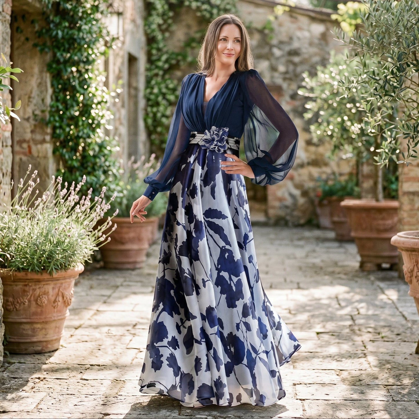 White&Wine Red - A woman posing in a floor-length navy and white floral chiffon maxi dress featuring a deep V-neckline, sheer balloon sleeves, and a 3D floral applique at the waist.