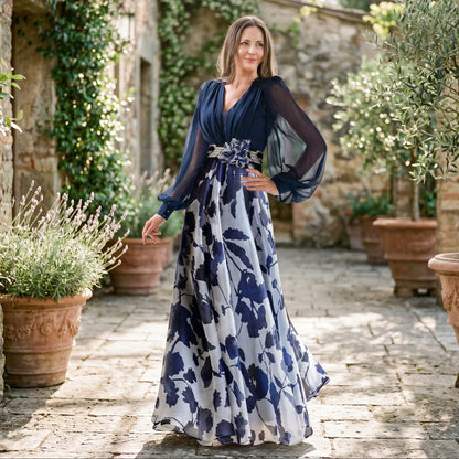 White&Wine Red - A woman posing in a floor-length navy and white floral chiffon maxi dress featuring a deep V-neckline, sheer balloon sleeves, and a 3D floral applique at the waist.