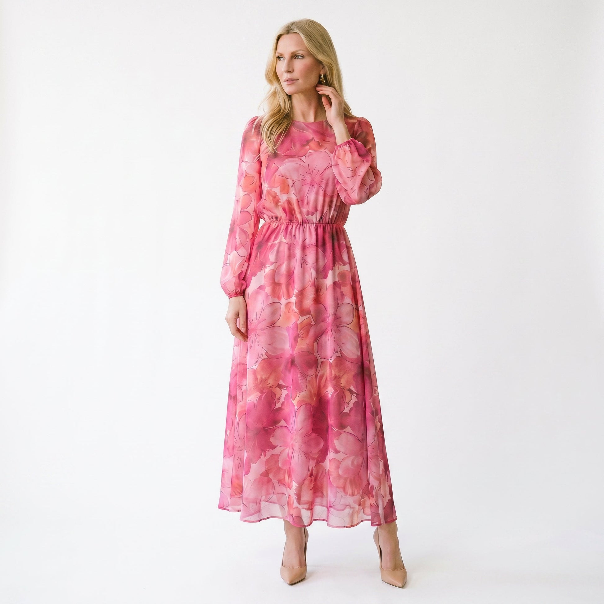 Pink - A woman stands wearing a blue and purple floral print chiffon midi dress with long sheer puff sleeves, a high neckline, and an A-line skirt, holding a gold clutch.