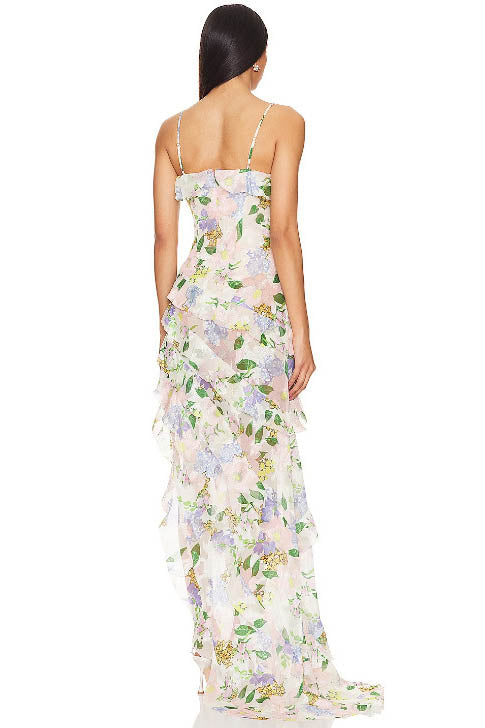Green - A model wearing a sleeveless maxi dress in a pastel floral print chiffon, featuring cascading ruffles, a V-neckline, and an asymmetric hem with a train.