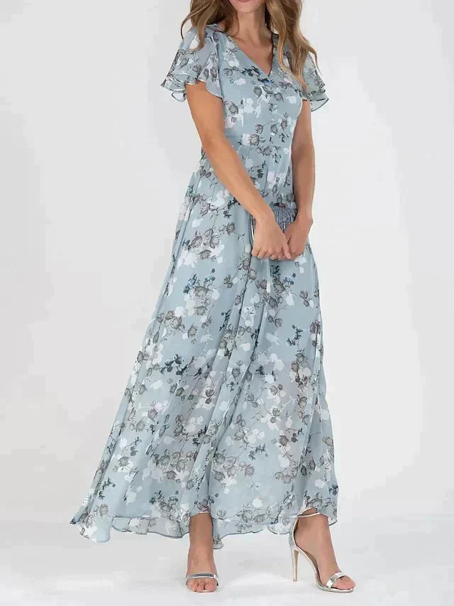 Blue - Women's light blue maxi dress featuring a white and grey floral print, V-neckline, short flutter sleeves, and a flowing sheer overlay skirt.