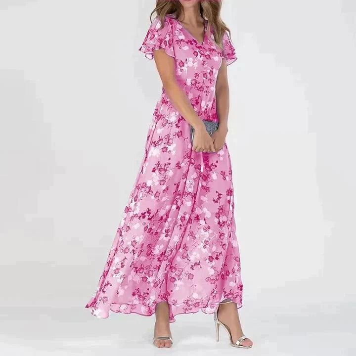 Pink - Women's light blue maxi dress featuring a white and grey floral print, V-neckline, short flutter sleeves, and a flowing sheer overlay skirt.