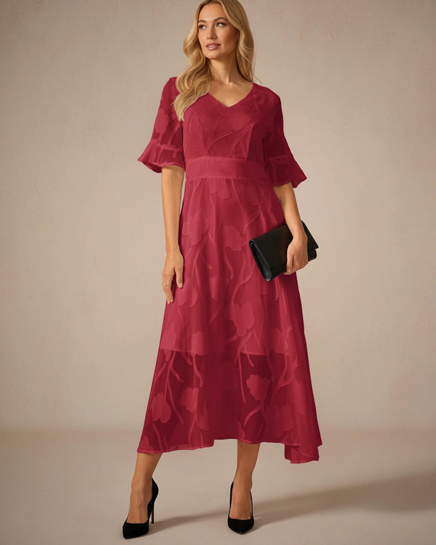 Red - A woman models a black formal midi dress featuring a V-neckline, flutter sleeves, and a textured floral jacquard overlay with a sheer hemline.