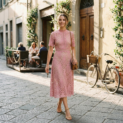 Light Blue - A woman wearing a black geometric lace midi dress with a high neck, short sleeves, and a defined waist, featuring a nude lining and scalloped hem.