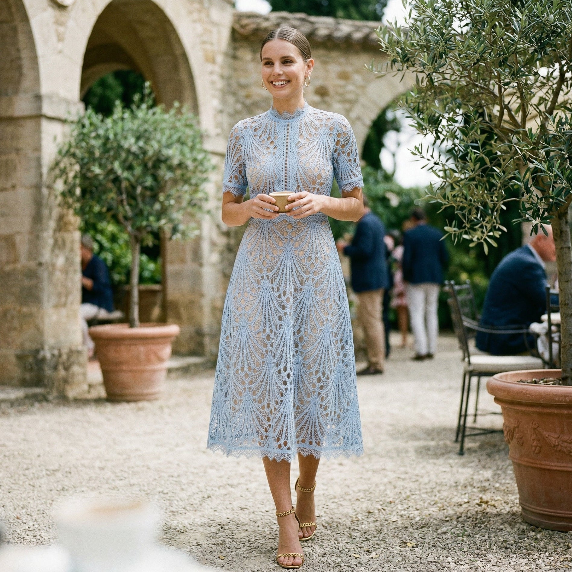 Light Blue - A woman wearing a black geometric lace midi dress with a high neck, short sleeves, and a defined waist, featuring a nude lining and scalloped hem.