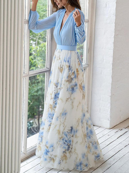 3XL - Woman modelling a long sleeve georgette maxi dress featuring a pleated bodice and a flowing layered skirt with a floral print.