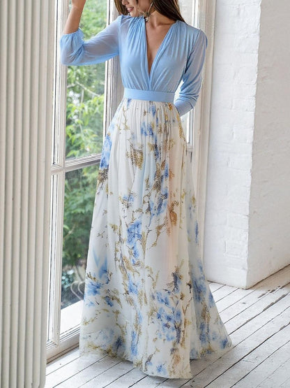 3XL - Woman modelling a long sleeve georgette maxi dress featuring a pleated bodice and a flowing layered skirt with a floral print.