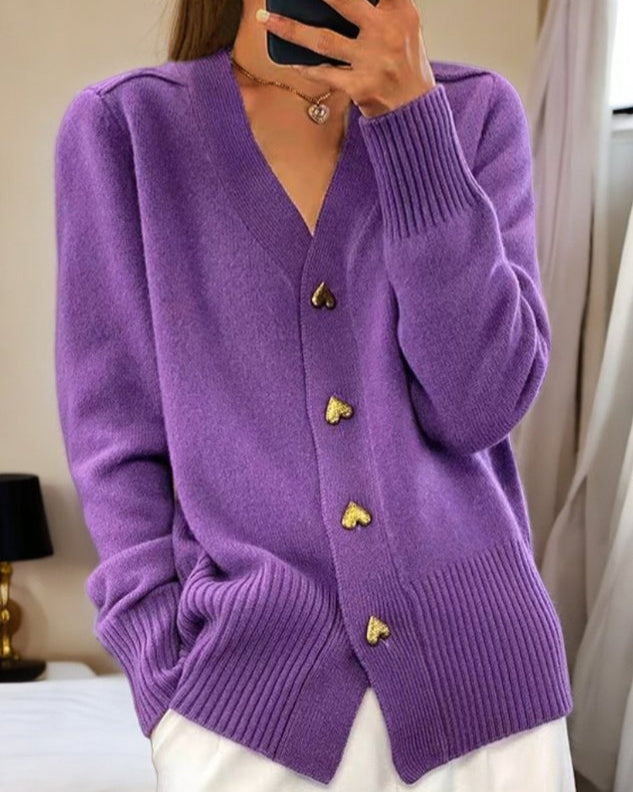 Violet - Women's grey V-neck knit cardigan featuring metallic gold heart-shaped buttons, drop shoulders, and wide ribbed cuffs and hem.