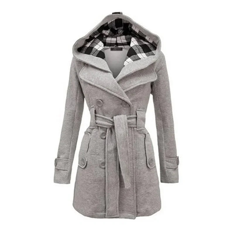 Light Grey - A woman wearing a cream-coloured, mid-length double-breasted trench coat with a hood, a tied waist belt, and black pants.