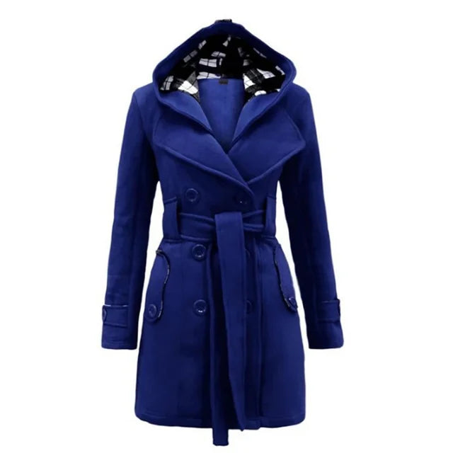 Blue - A woman wearing a cream-coloured, mid-length double-breasted trench coat with a hood, a tied waist belt, and black pants.