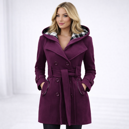 Purple - A woman wearing a cream-coloured, mid-length double-breasted trench coat with a hood, a tied waist belt, and black pants.
