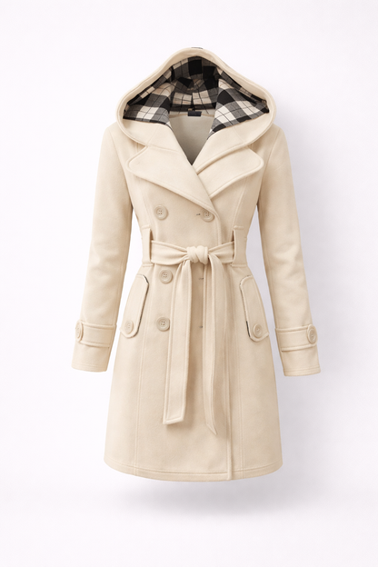 Beige - A woman wearing a cream-coloured, mid-length double-breasted trench coat with a hood, a tied waist belt, and black pants.