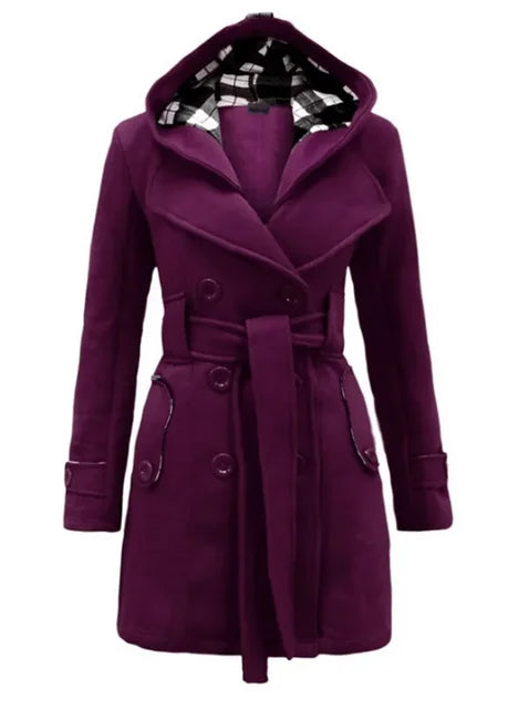 Purple - A woman wearing a cream-coloured, mid-length double-breasted trench coat with a hood, a tied waist belt, and black pants.