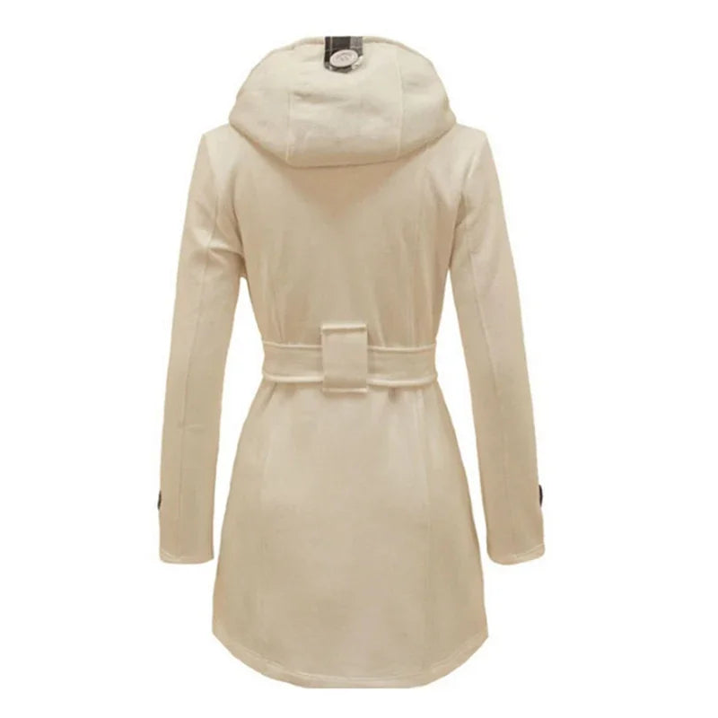 Bordeaux Red - A woman wearing a cream-coloured, mid-length double-breasted trench coat with a hood, a tied waist belt, and black pants.