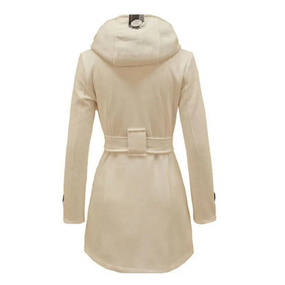 Bordeaux Red - A woman wearing a cream-coloured, mid-length double-breasted trench coat with a hood, a tied waist belt, and black pants.