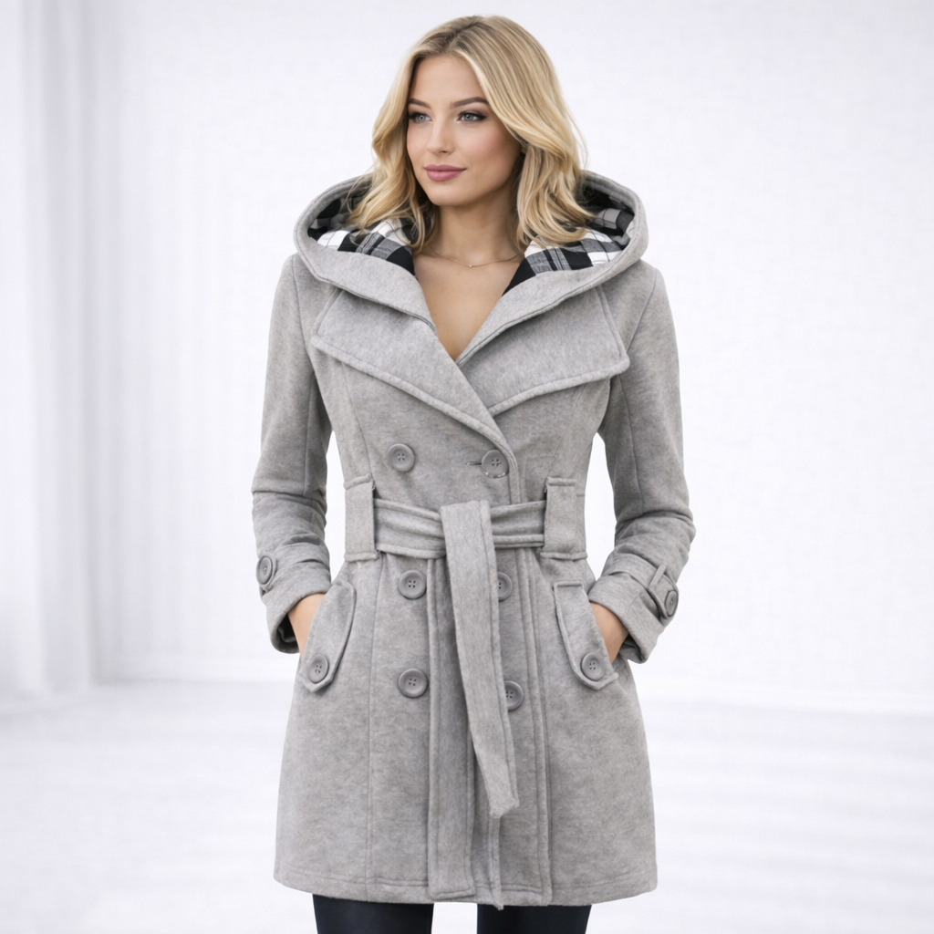 Light Grey - A woman wearing a cream-coloured, mid-length double-breasted trench coat with a hood, a tied waist belt, and black pants.