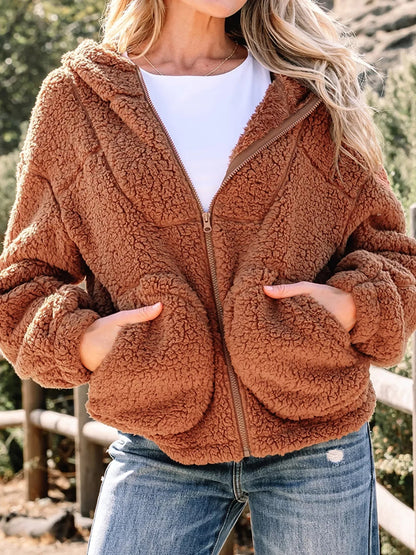Brown - Women's brown hooded teddy fleece jacket with front zipper and patch pockets, worn over a white t-shirt and jeans.