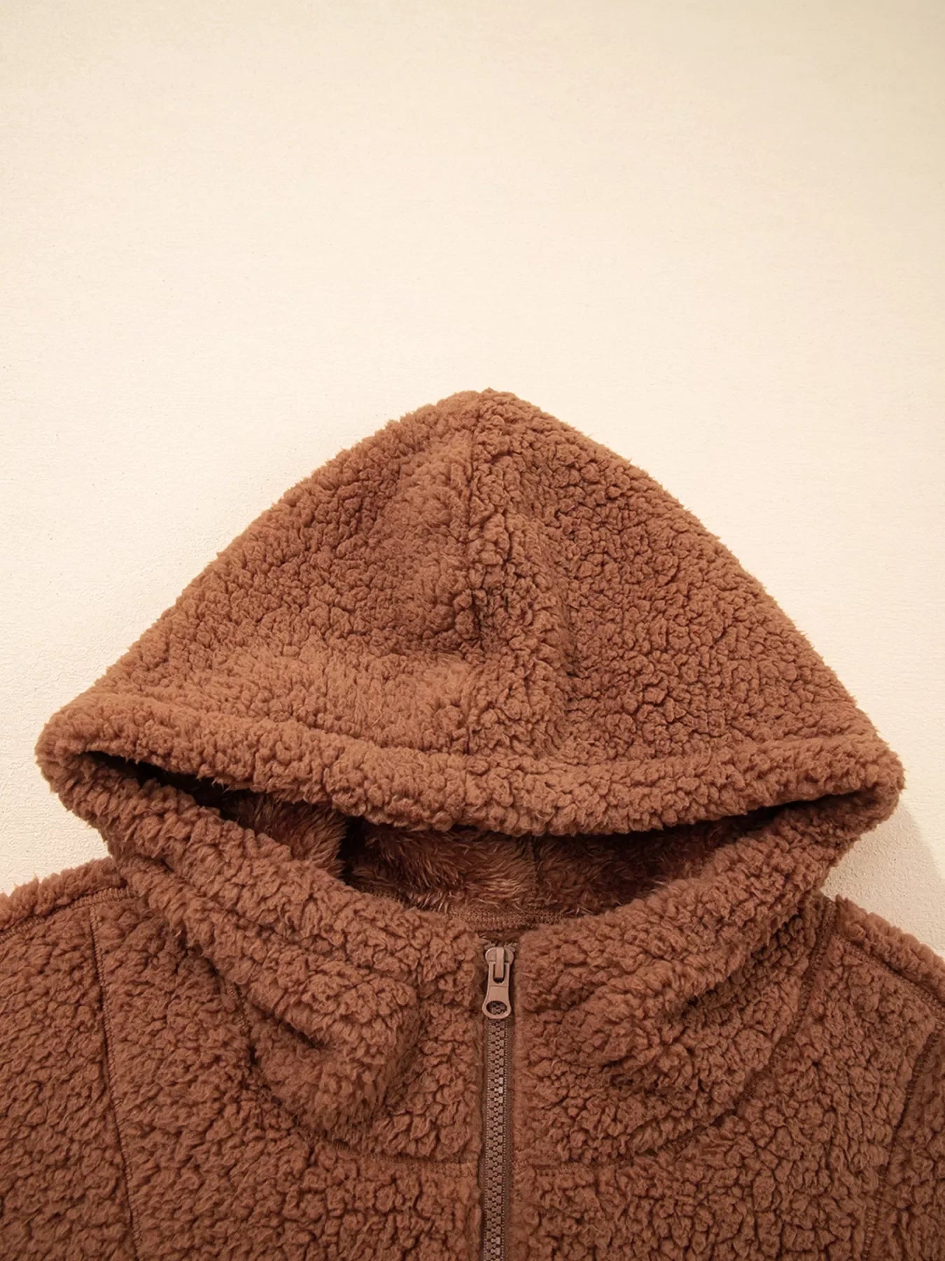 Brown - Women's brown hooded teddy fleece jacket with front zipper and patch pockets, worn over a white t-shirt and jeans.