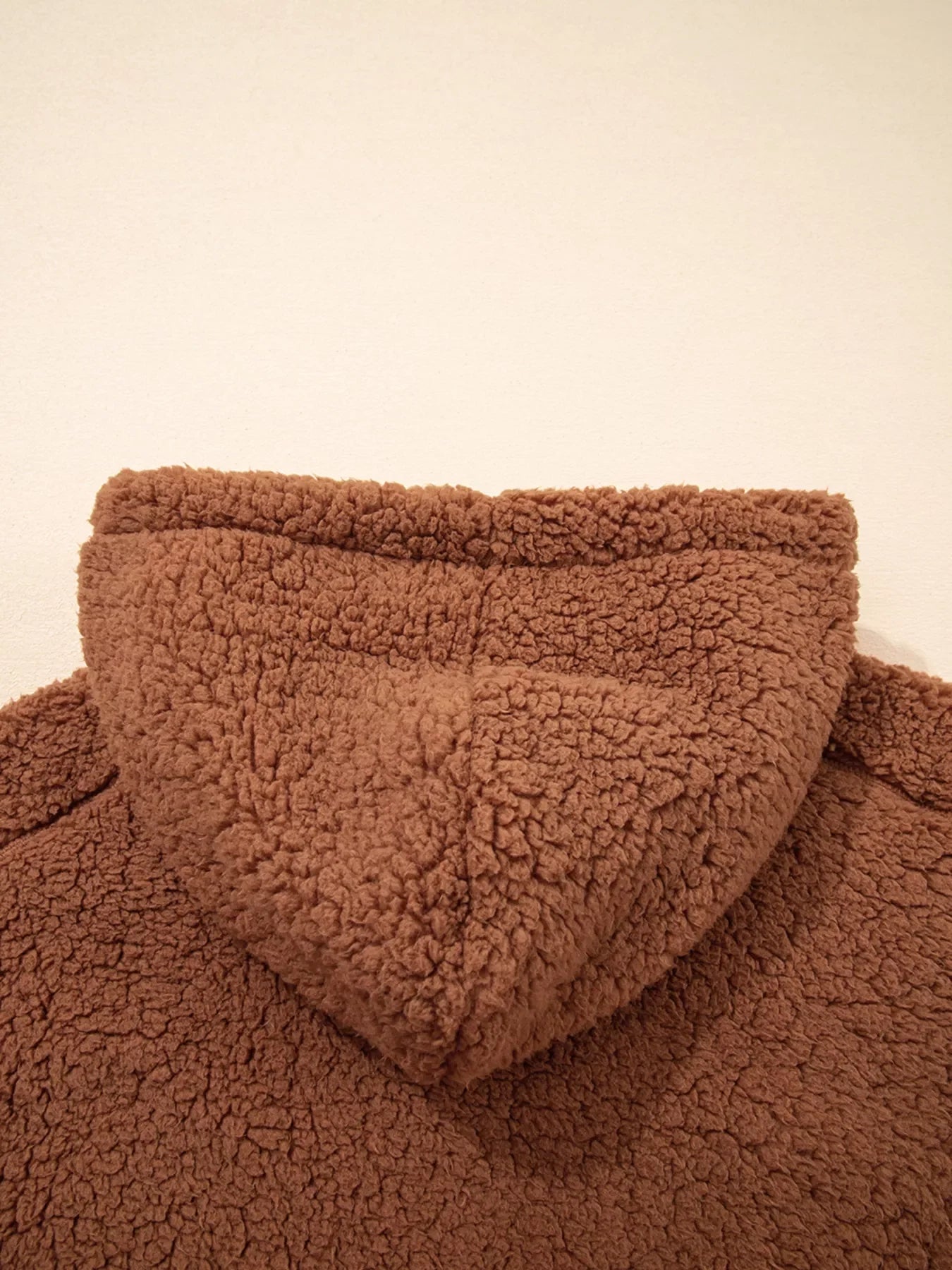 Brown - Women's brown hooded teddy fleece jacket with front zipper and patch pockets, worn over a white t-shirt and jeans.