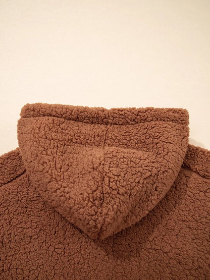 Brown - Women's brown hooded teddy fleece jacket with front zipper and patch pockets, worn over a white t-shirt and jeans.
