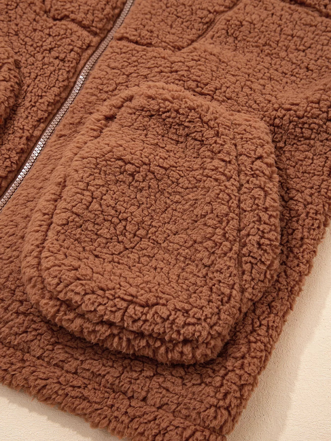 Brown - Women's brown hooded teddy fleece jacket with front zipper and patch pockets, worn over a white t-shirt and jeans.