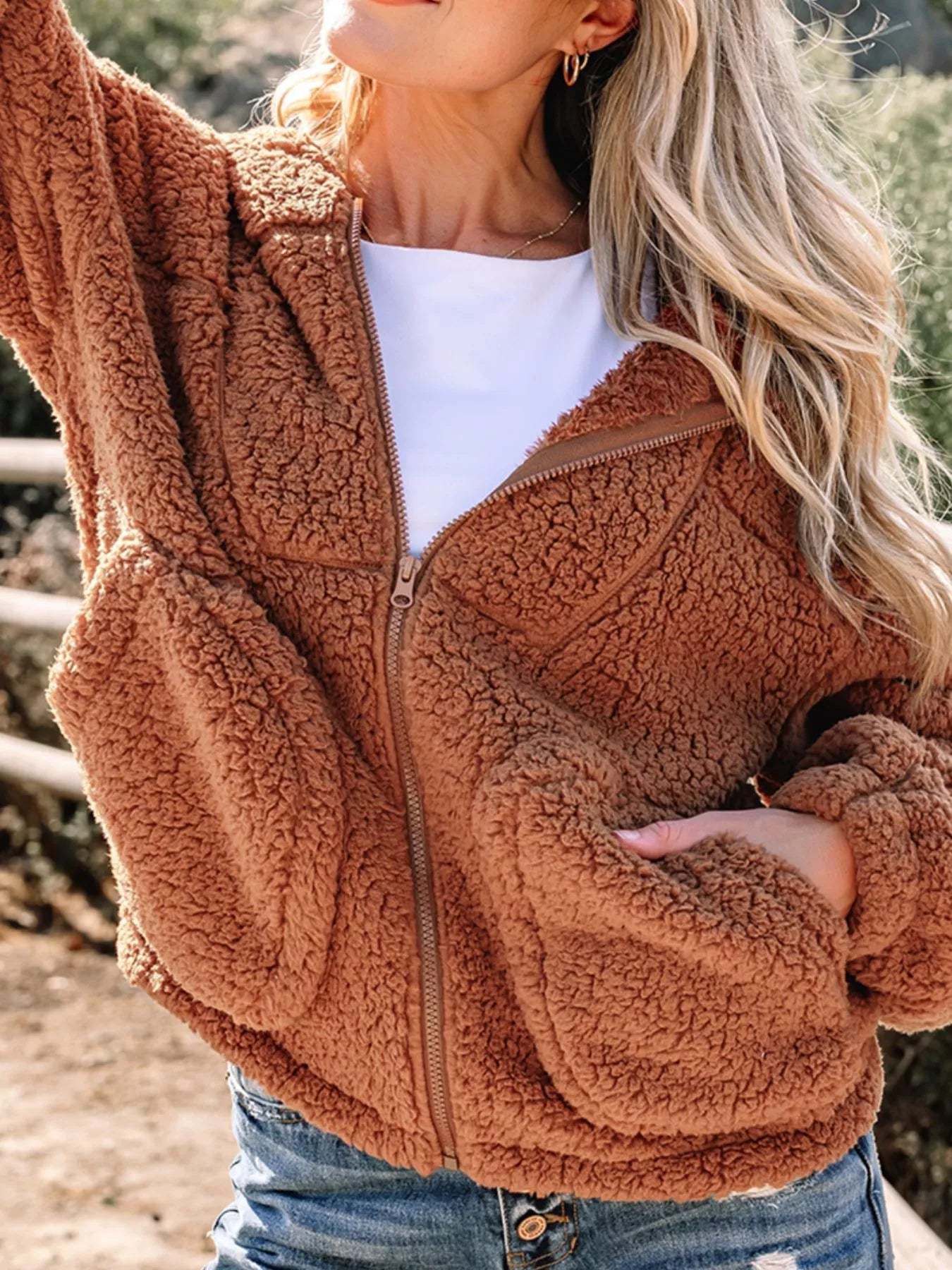 Brown - Women's brown hooded teddy fleece jacket with front zipper and patch pockets, worn over a white t-shirt and jeans.