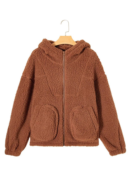 Brown - Women's brown hooded teddy fleece jacket with front zipper and patch pockets, worn over a white t-shirt and jeans.
