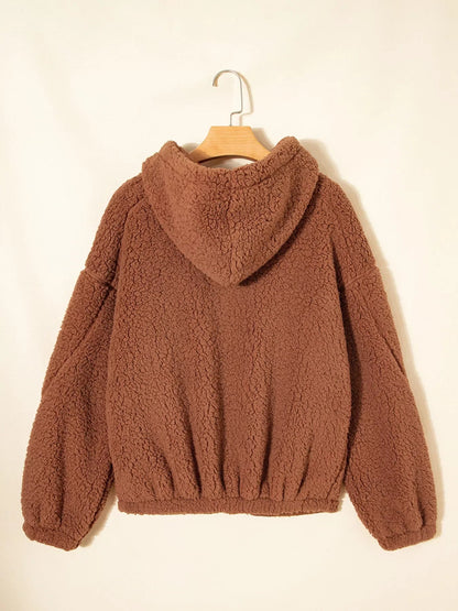 Brown - Women's brown hooded teddy fleece jacket with front zipper and patch pockets, worn over a white t-shirt and jeans.
